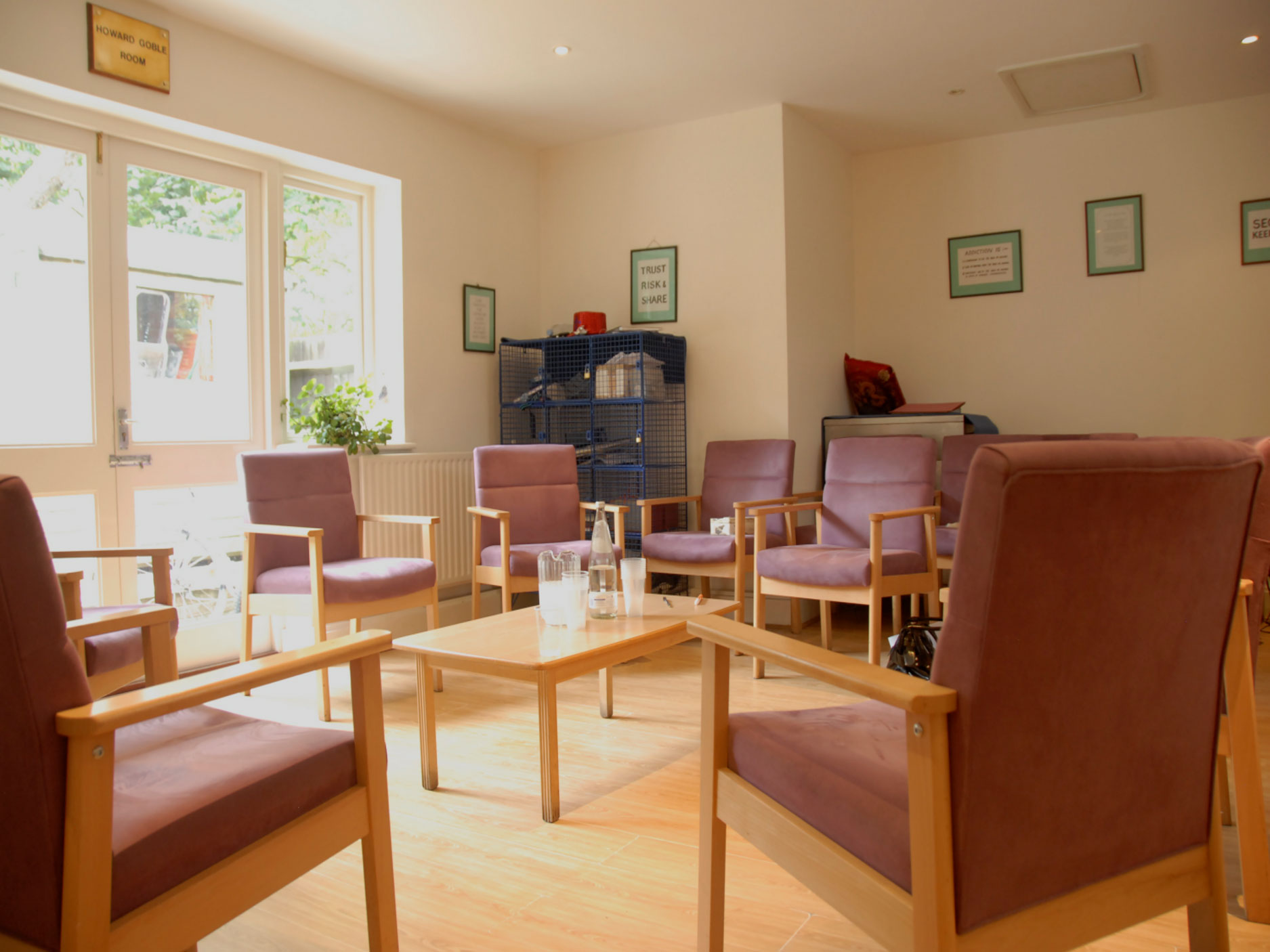 Mount CArmel Group Room - a sunny room with large windows and a number of  armchairs centred around a coffee table