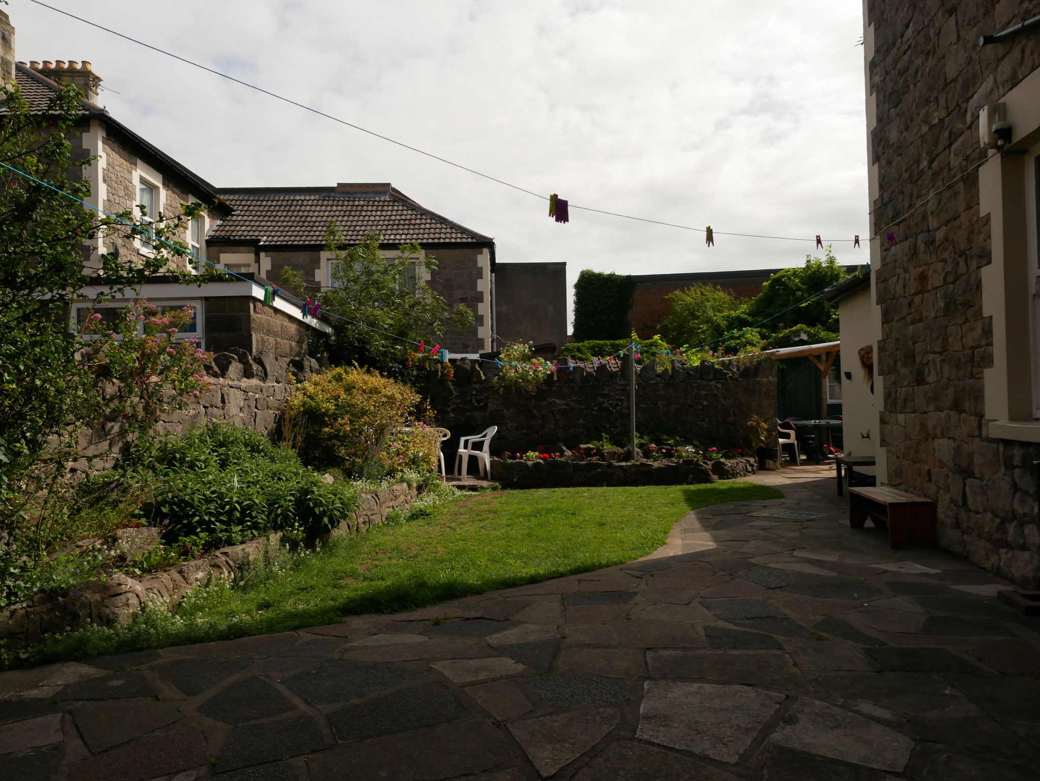 Western Counselling - outside. A patch of grass and a patio area surrounded by buildings
