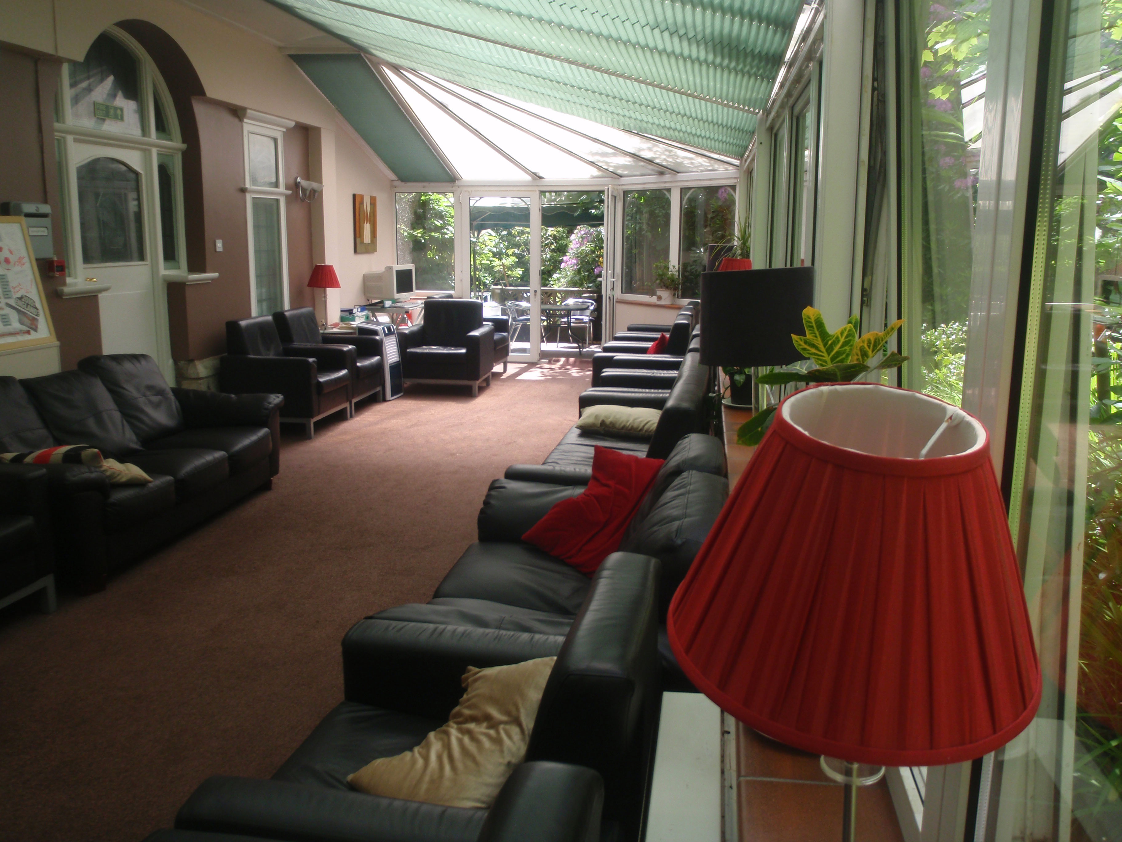 A long conservatory with a number of sofas facing in to each other