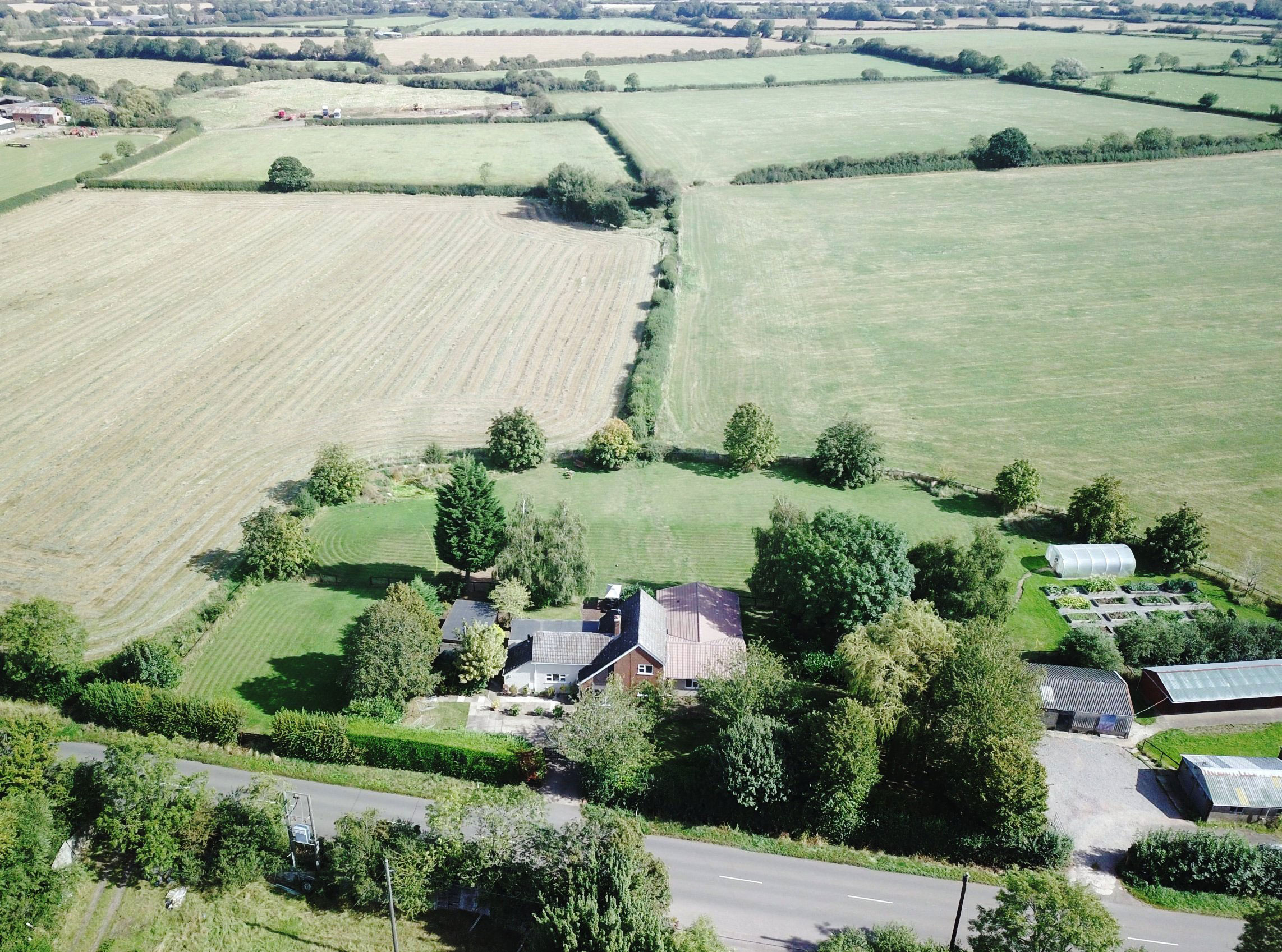 An aerial view of ESH community - the building and grounds are surrounded by fields and trees