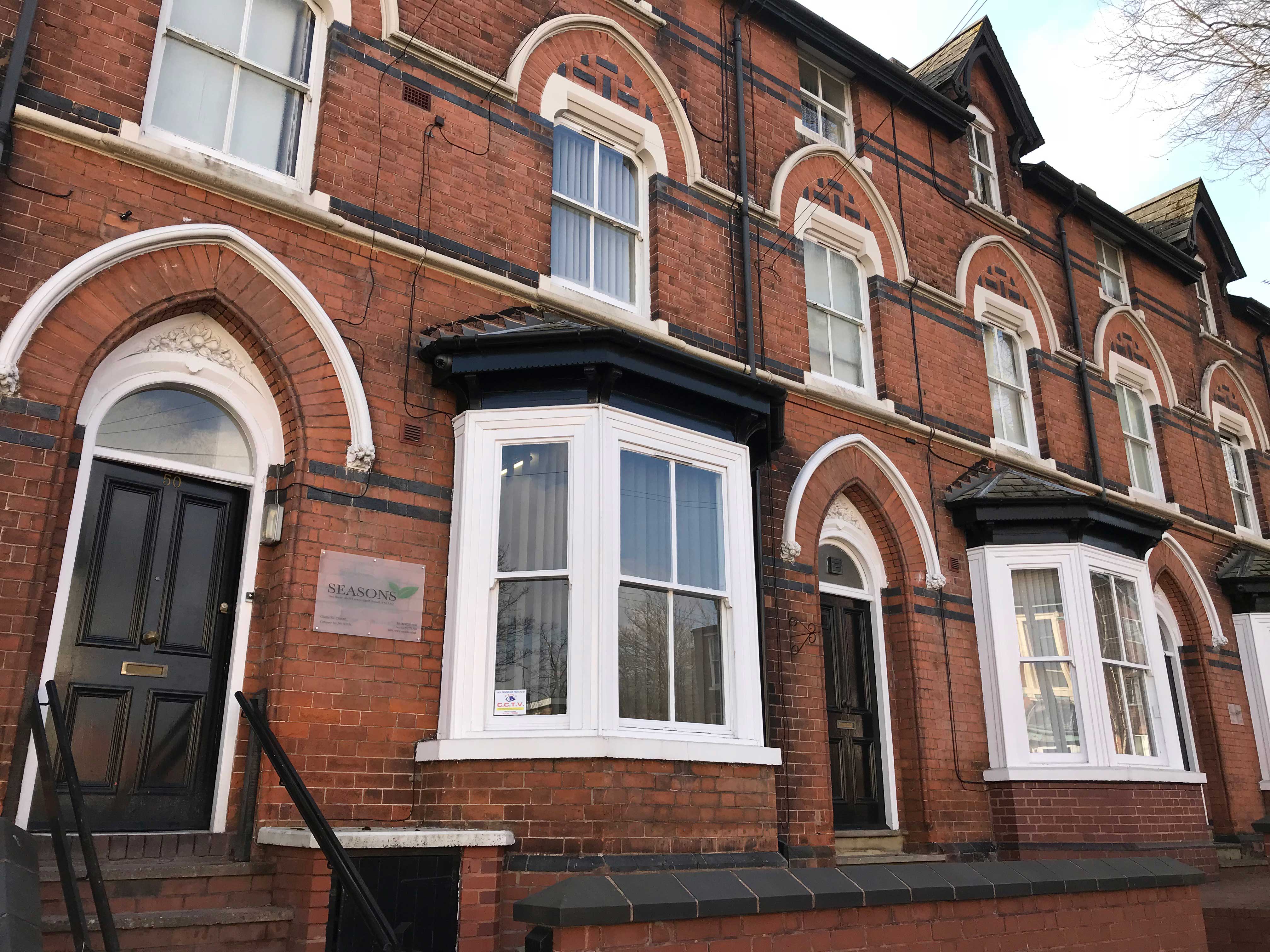The outside of a house with big windows.