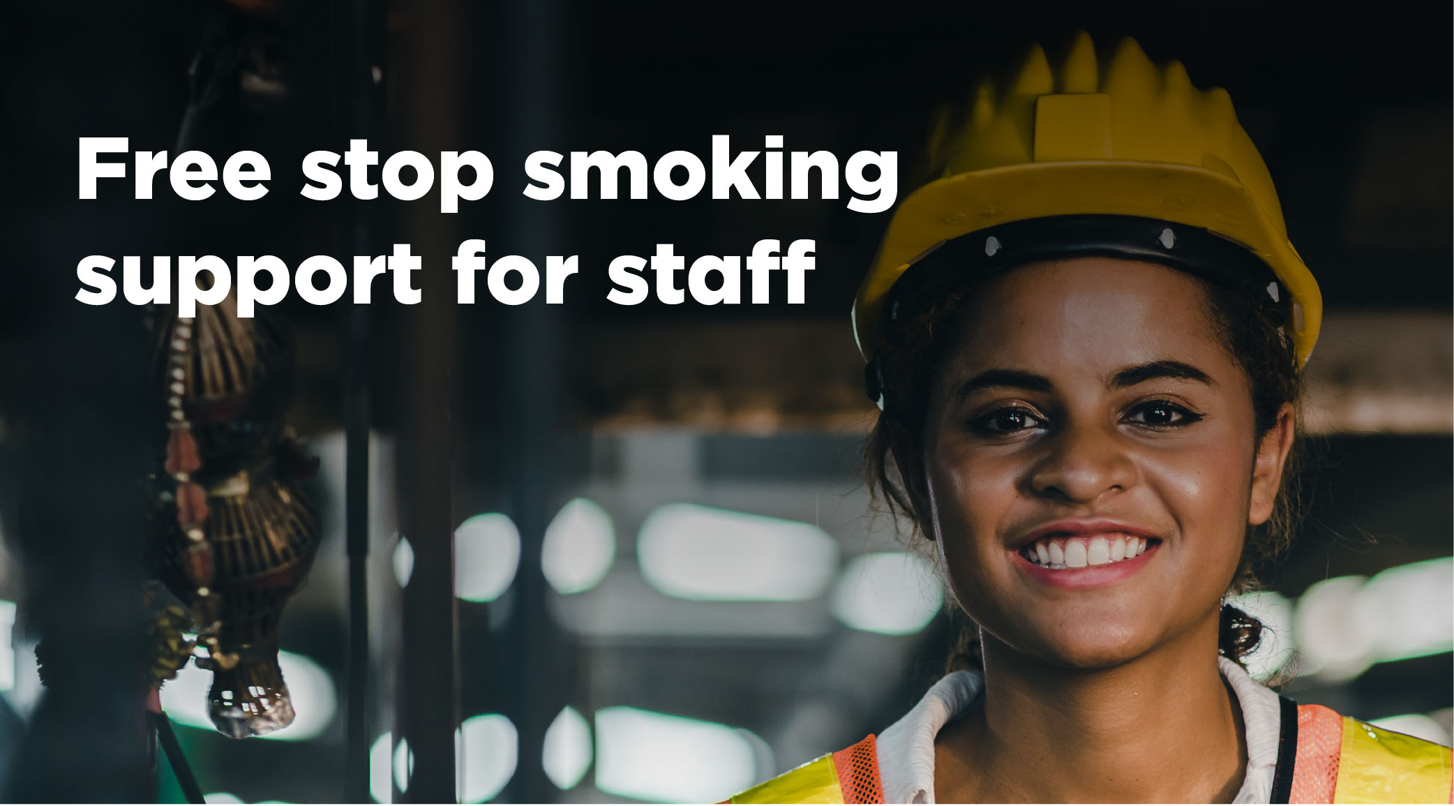 A woman wearing a hard hat and high-vis jacket. The words Free stop smoking support for staff
