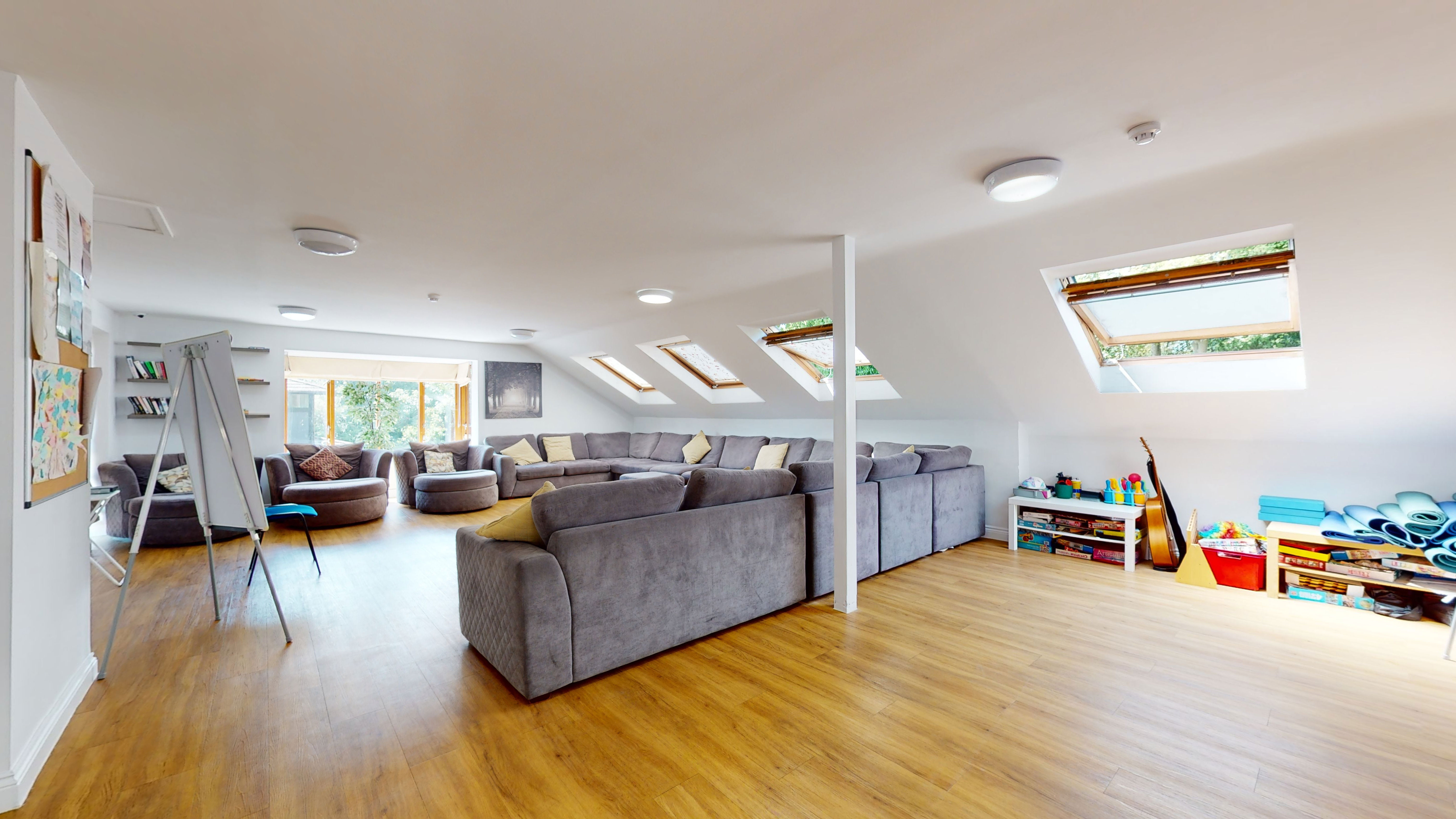An open, airy room with sofas around the edge