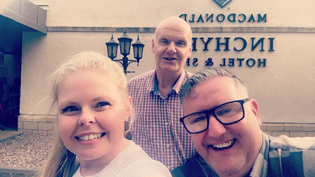Two men and a woman taking a selfie