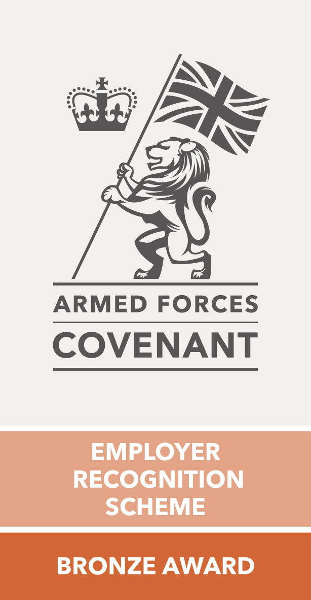 The Armed Forces Covenant Logo which is a Lion stood up on it's hind legs, carrying the Union Jack flag with a crown floating next to it. There is text below reading: "Armed Forces Covenant, Employer Recognition Scheme, Bronze Award