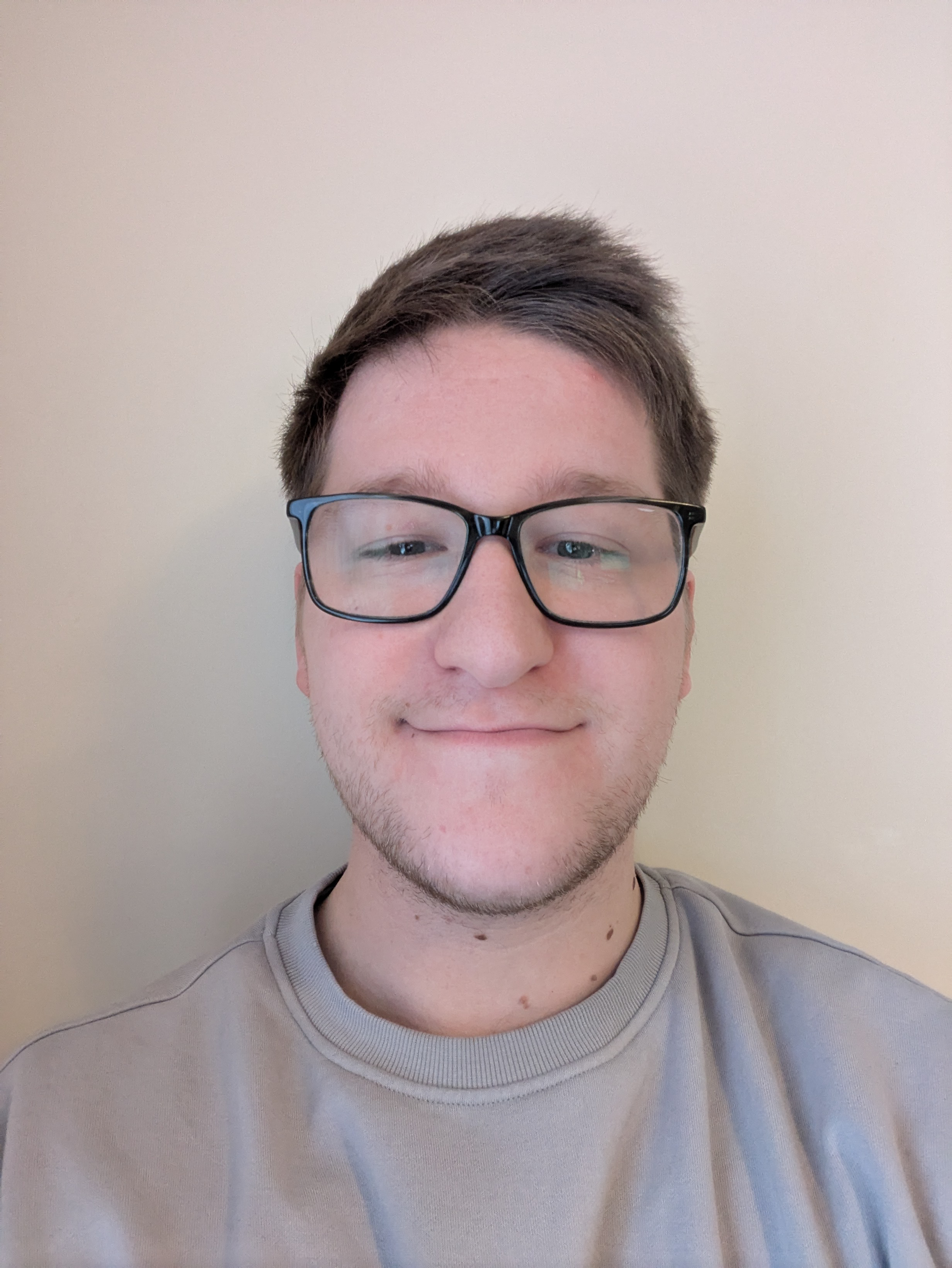 A young person wearing glasses with short hair