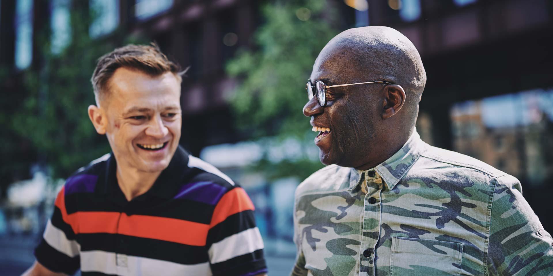 two men talking and smiling