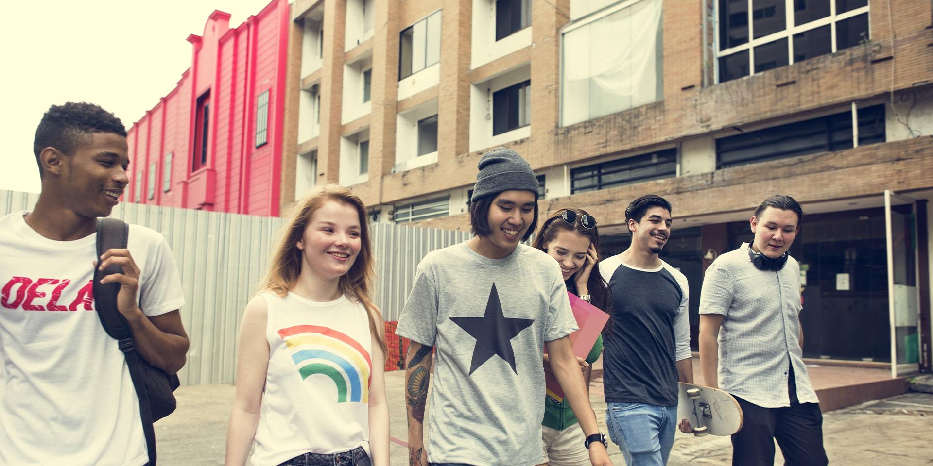 Large group of young people walking and laughing