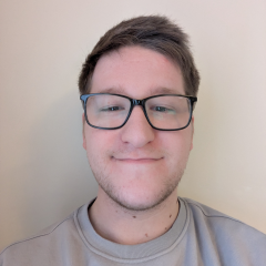 A young man wearing glasses