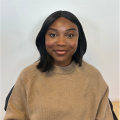 A young Black woman with shoulder length black hair