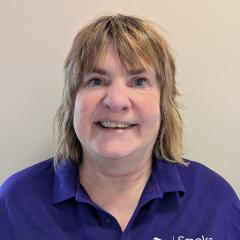 Lorraine has short blonde hair and a fringe