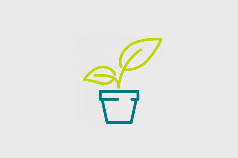 A plant pot with a leaf sprouting out of the top