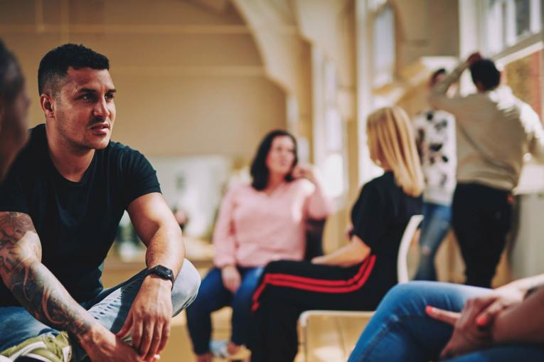 A group of people are sitting having a conversation