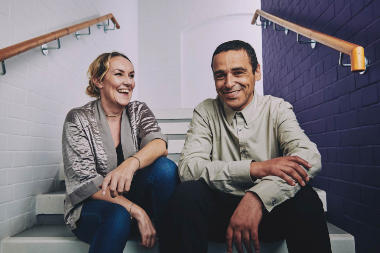 two people sitting on the stairs smiling