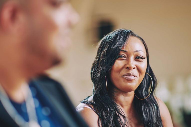 A woman is smiling at a man