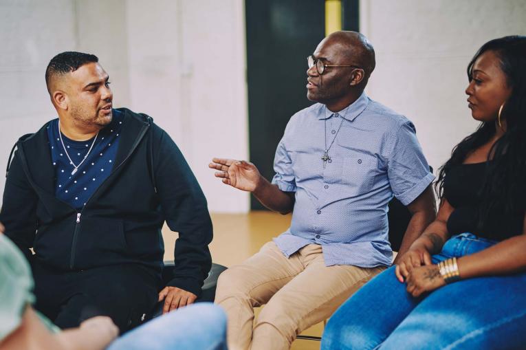 A group of people are sitting having a conversation