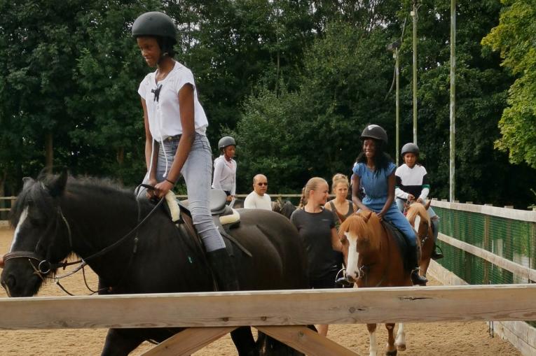 Young people riding horses