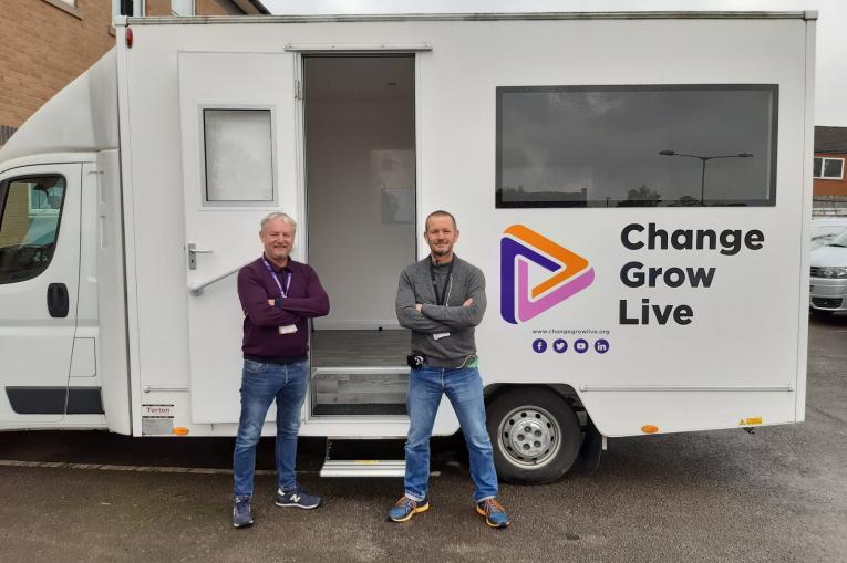 Two men stood in front of a Change Grow Live van
