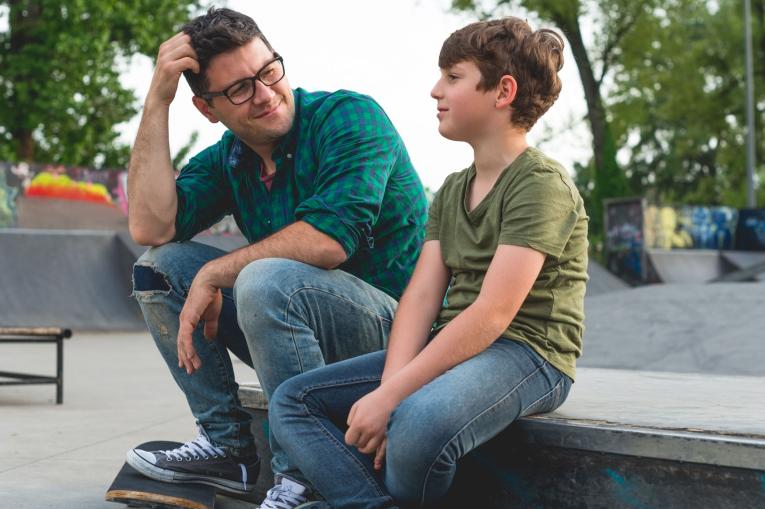 A man and a child at a skatepark