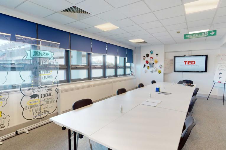 Wear alcohol recovery - groups and meetings. A meeting room with a screen, a large white table and white walls