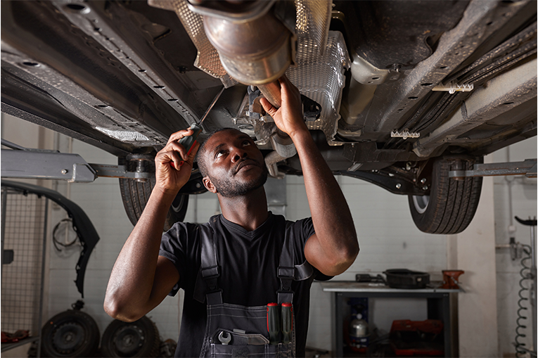 A man is working on a car in a garage