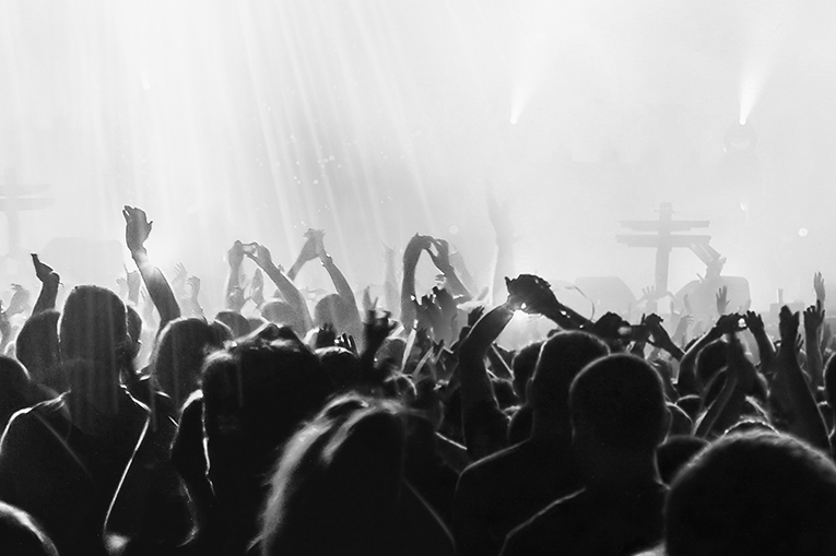 Black and white image of a large crowd at a gig