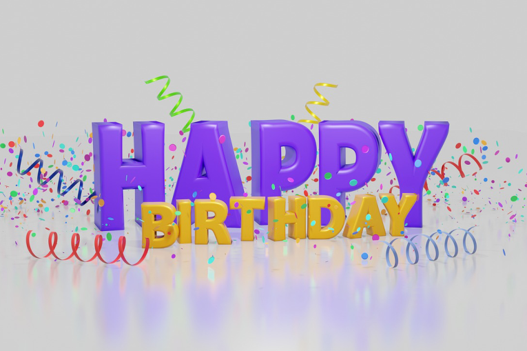 Happy Birthday with spirals of confetti coming off it