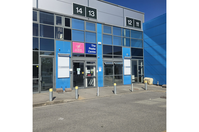 The outside of a glass building, with blue squares making up the glass panels