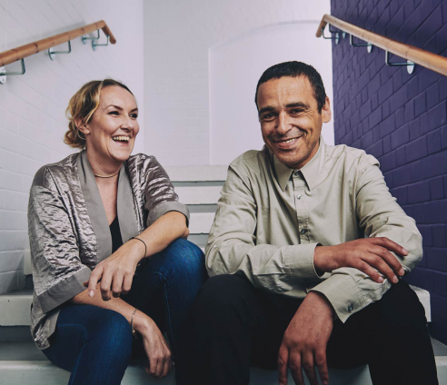 two people sitting on the stairs smiling