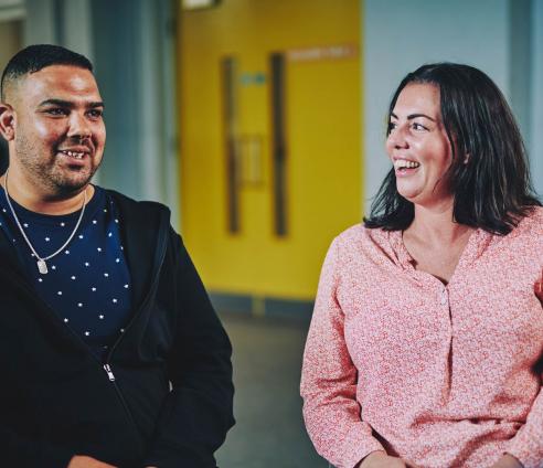 A woman and a man are sitting together having a conversation