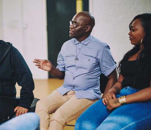 A group of people are sitting having a conversation