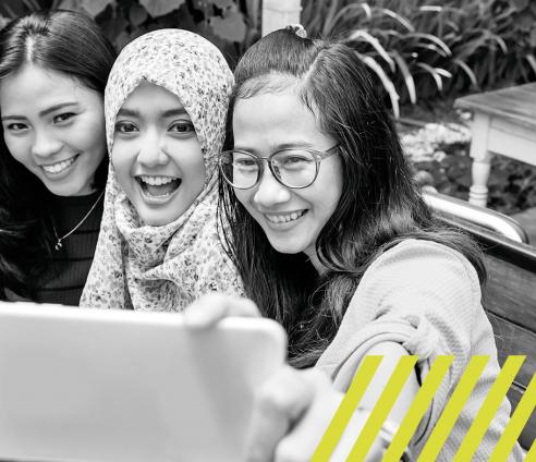 Three young people taking a group selfie