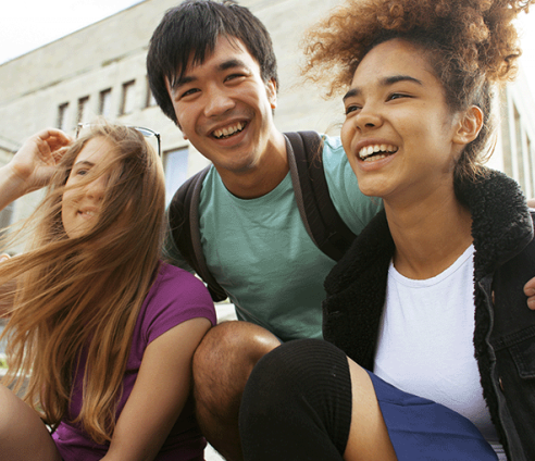Trio of young people laughing