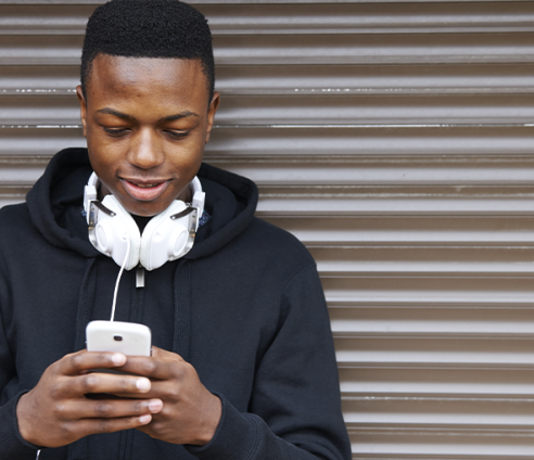 Young person looking down at phone