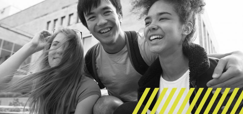 three teenagers smiling and laughing