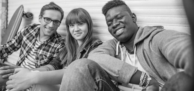 Three young people taking a group selfie