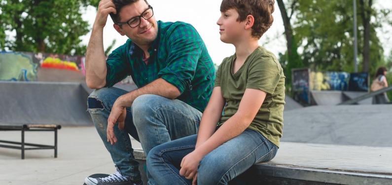 A man and a child at a skatepark