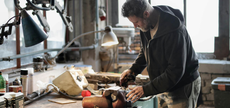 A man doing woodwork in a workshop
