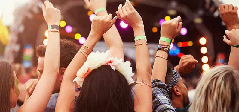 Image of a crowd at a festival watching a performance