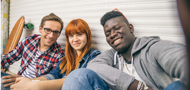 Three young people smiling for the camera