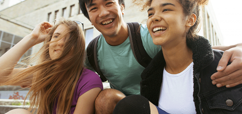 Trio of young people laughing