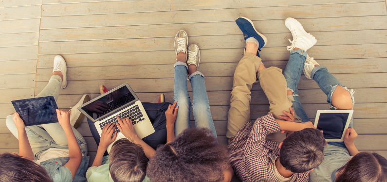A top down photo showing a group of young people sat together