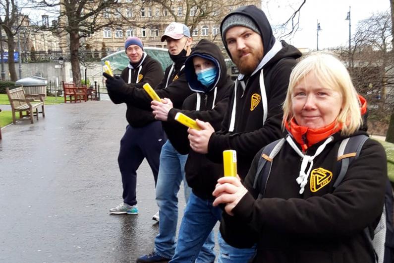 A team of people holding naloxone