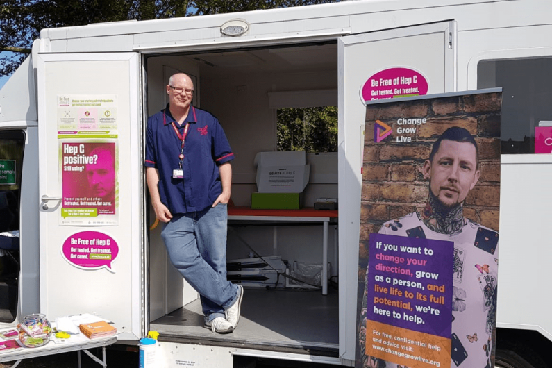 A man stood in the doorway of a hepatitis c testing van