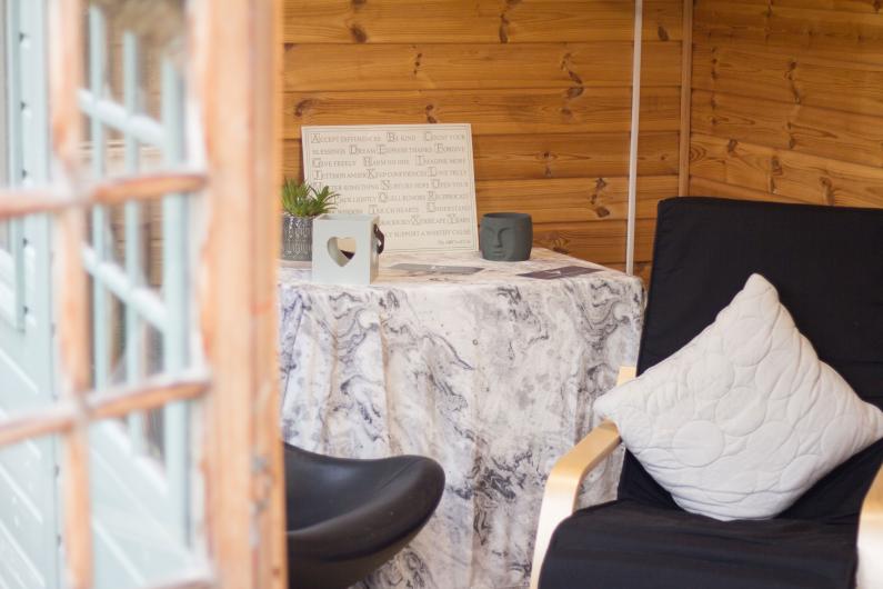 A photo of two chairs with cushions on them, placed in a shed 