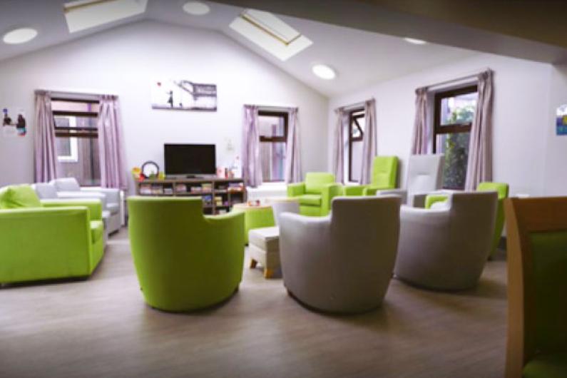 Athena Group Room - a room with white walls, a vaulted ceiling and comfortable green armchairs facing the centre