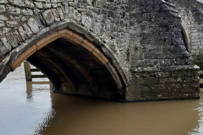 A photo of a stone bridge over a river