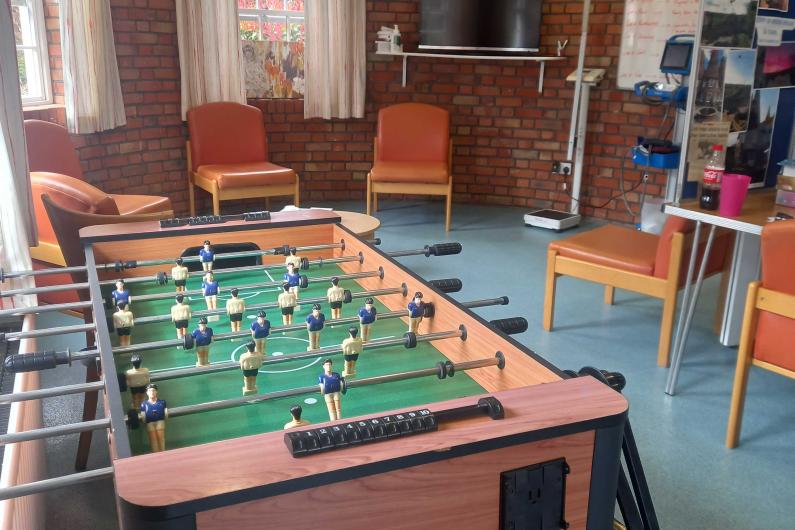 A games room with a football table