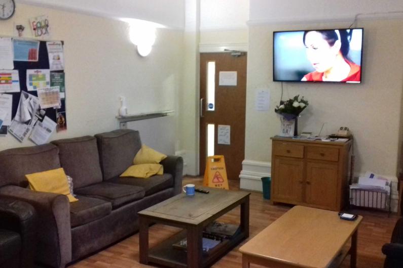 Leigh bank - communal room with sofa, notice board, coffee tables and at tv