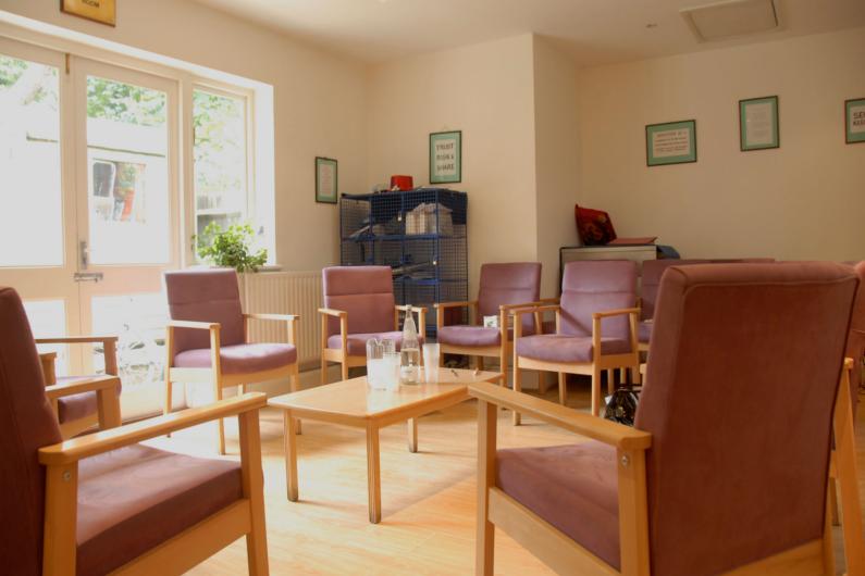 Mount CArmel Group Room - a sunny room with large windows and a number of  armchairs centred around a coffee table